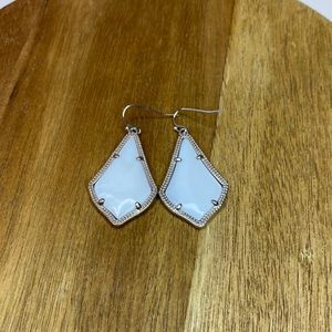 Kendra Scott white stone drop earrings.